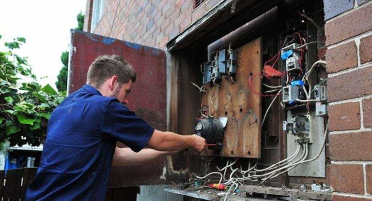 Electrician working on old switch board